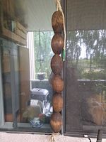 Full strand of six wooden floats on rope hanging