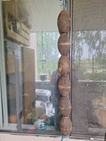 Full strand of six wooden floats hanging
