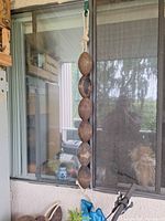 Full view of six cedar floats hanging on hemp rope
