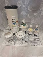 All seven ceramic chef motif pieces grouped on tray