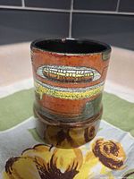 Front view showing maize motif and glazing