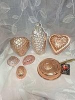 Group shot of seven copper/copper-plated molds