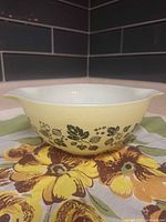 Full view of yellow Pyrex Gooseberry bowl showing color, pattern, and shape
