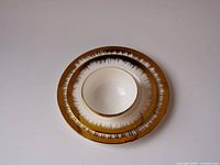 Stacked view showing 10-in plate, 8-in plate and 5-in bowl with metallic brown rim pattern