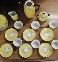 Full 21-piece yellow lustreware miniature tea set laid out