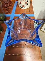 Top view showing star-shaped rim and blue crystal glass