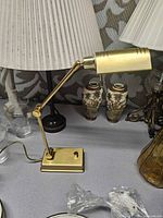 Left side view of brass adjustable lamp on tabletop