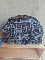 Exterior of DVF navy monogram overnight bag
