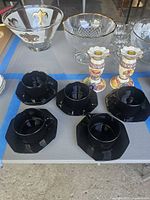 Group shot of all items: 5 black teacups, 6 saucers, 2 Harvest Time candlesticks