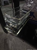 Stack of three clear rectangular glass baking pans on shelf