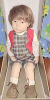 Full view of Sigikid Stan II doll inside original box