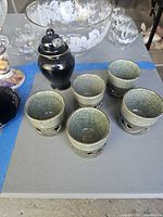 Group shot of five Somayaki teacups and black ginger jar