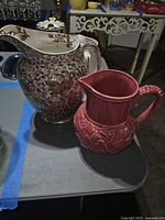 Ridgways brown floral pitcher and Lenox deep pink pitcher side by side