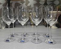Front view of seven Marquis by Waterford white wine glasses showing labels