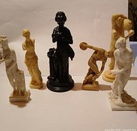 Group shot of all six statues showing size, colour and design