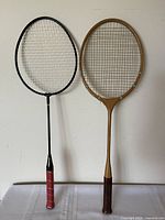 Front view of both rackets showing overall design, materials, and grip styles