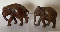 Front and side view of both hardwood elephant figurines