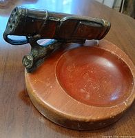 Front three-quarter view showing golf bag, branch stand, and wooden basin
