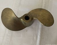 Top view showing both blades and hub of brass propeller