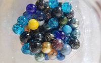 Top view of assorted speckled, crackle and swirl marbles