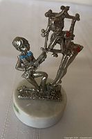 Front view showing couple, marble base and label
