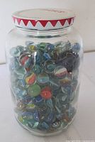 Full view of glass jar with lid and marble contents