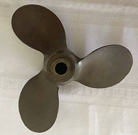 Front view of 3-blade bronze propeller showing blade shape and hub markings