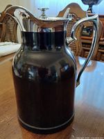 Full side view of carafe showing Bakelite body and chrome handle
