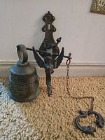 Full view of bell, bracket, angel pivot, counterweight and chain