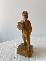Front view of signed wood carving showing figure and base