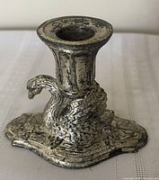 Front left view showing swan figure and fluted cup