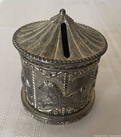 Front view showing coin slot and embossed horse panels