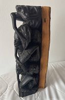 Front view showing stacked ebony figures and sapwood rear section