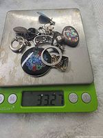 Group of jewelry on scale reading 33.27 g