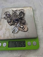 Pile of mixed sterling pieces on scale reading 51.55 g