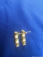Pair of gold-tone bar stud earrings, posts visible