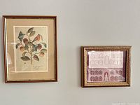 Both framed artworks hanging on wall