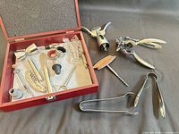 Overall lot with wooden box open displaying bar tools; lever corkscrew parts and ice tongs beside the box