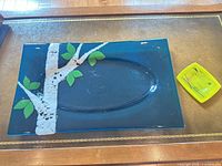 Large blue fused glass platter with birch tree motif and small yellow dish