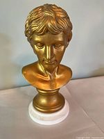 Front view of gold-finished Roman-style bust
