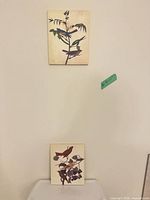 Both canvases displayed vertically on wall for size reference