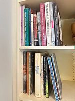 Two shelves filled with assorted cookbooks