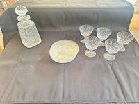 Group shot showing decanter, stack of plates, and five sherbet glasses