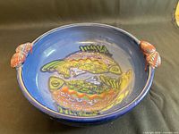 Top view showing entire blue bowl with interior fish design