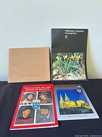 Front covers of four softcover reference books