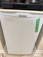 Front view of Kenmore compact refrigerator showing brand badge and overall exterior