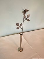 Full view of metal rose in narrow vase