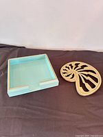 Both the napkin holder and trivet side by side for scale and overview
