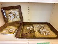 Three melamine trays showing sizes and floral design