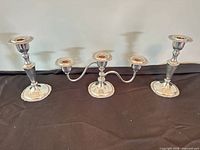 Front view showing three-light candelabra flanked by two single candlesticks